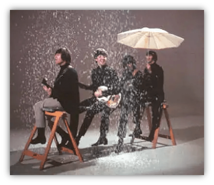 "Iconic band performing in a playful, rainy scene with an umbrella."