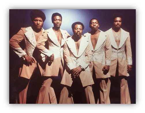 "Five men in stylish beige suits with white accents, posing together against a blue background."