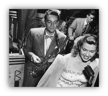 "Vintage jazz performance featuring a saxophonist and a female vocalist."