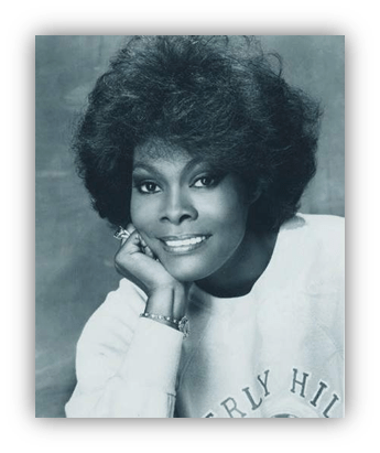 "Black and white portrait of a smiling woman with voluminous hair, wearing a Beverly Hills sweatshirt."