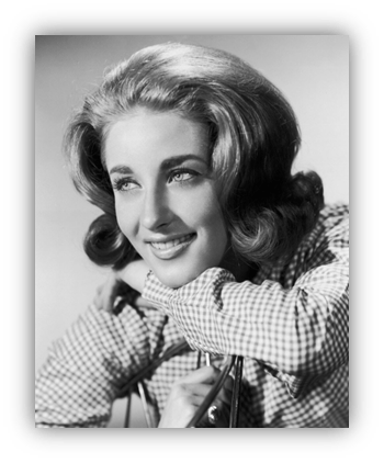 Smiling woman with stylish hair in black and white portrait.