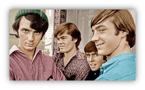 "Four young men posing together, showcasing 1960s fashion and hairstyles."