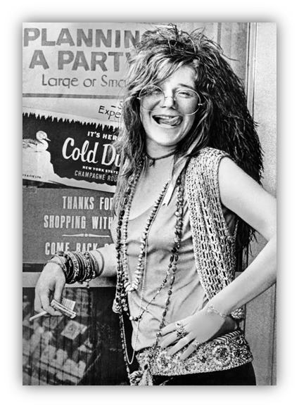 "Black and white photo of a woman with wild hair and glasses, smiling against a party planning sign."