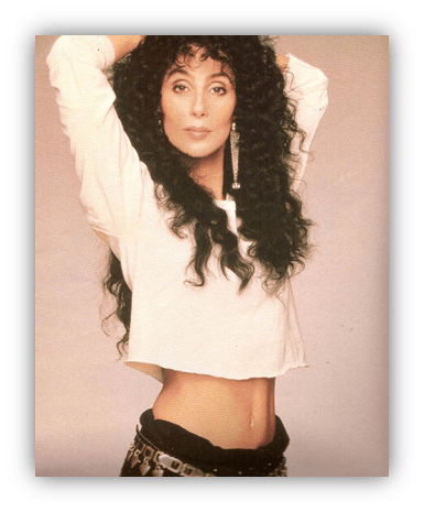 Cher posing in a stylish outfit with curly hair and a confident expression.