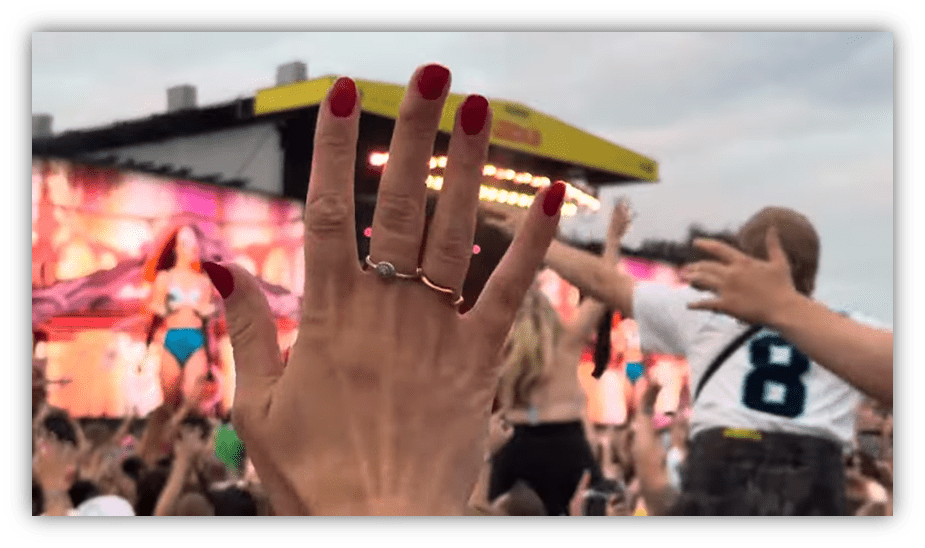 "Audience enjoying a live concert with raised hands and vibrant stage lights."