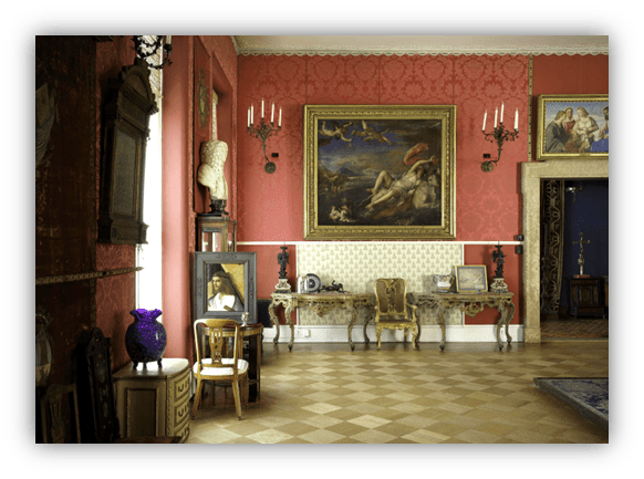 Elegant interior of a historic room featuring ornate decor, classic paintings, and antique furniture.