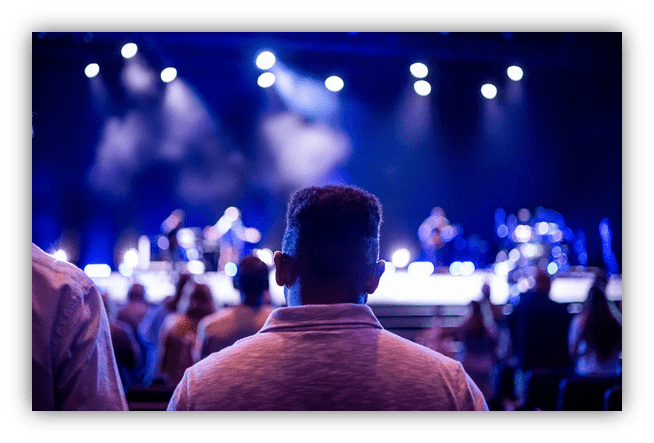 "Audience enjoying a live music performance with stage lights."