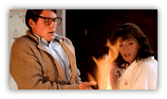 "Scene from a classic movie featuring a man in glasses and a woman in a robe, surprised by a fire."
