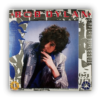 "Bob Dylan's 'Empire Burlesque' album cover featuring a pensive pose in a stylish blazer."