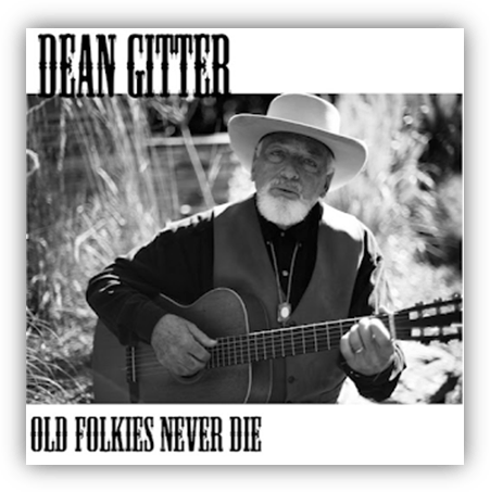 "Dean Gitter holding a guitar, featured on the album cover 'Old Folkies Never Die'."