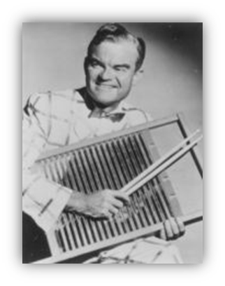"Man in vintage attire playing a washboard instrument, smiling."