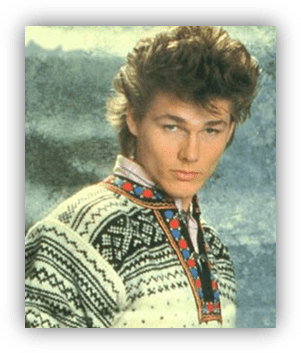 Young man in a patterned sweater, showcasing a retro hairstyle.