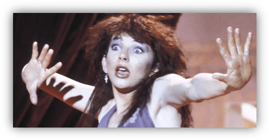 "Dynamic performance by a female singer with dramatic expression and wild hair."