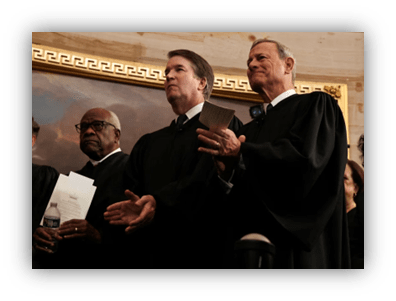 Supreme Court justices in formal attire at a ceremony.
