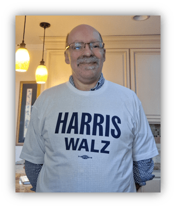 Man wearing a "HARRIS WALZ" t-shirt in a kitchen setting.
