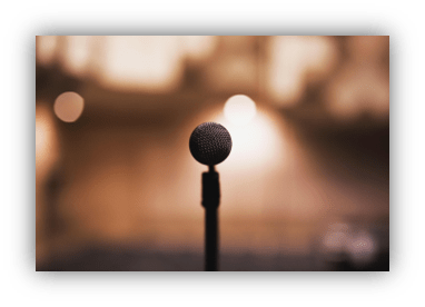 Microphone on stage with blurred background lights.
