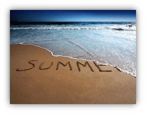 "Word 'SUMMER' written in sand on a beach, with ocean waves in the background."