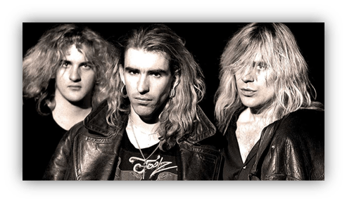 "Black and white photo of a rock band with long hair and leather jackets."