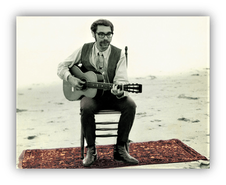 "Man playing guitar on a rug at the beach, vintage style photo."