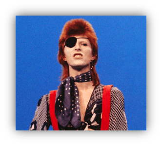 David Bowie as Ziggy Stardust, wearing an eye patch and colorful attire against a blue background.